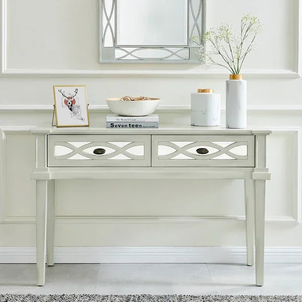 Cream console table with two drawers, decorative vases, framed art, and bowl in hallway