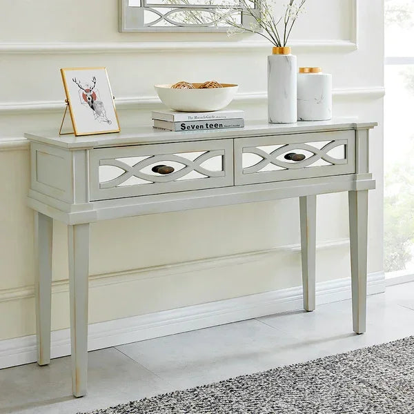 Light grey hallway console table with two drawers, decorative front, and home decor items