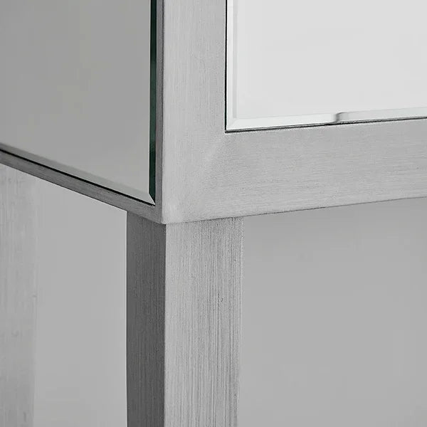Brushed silver side table leg with mirrored panel close-up