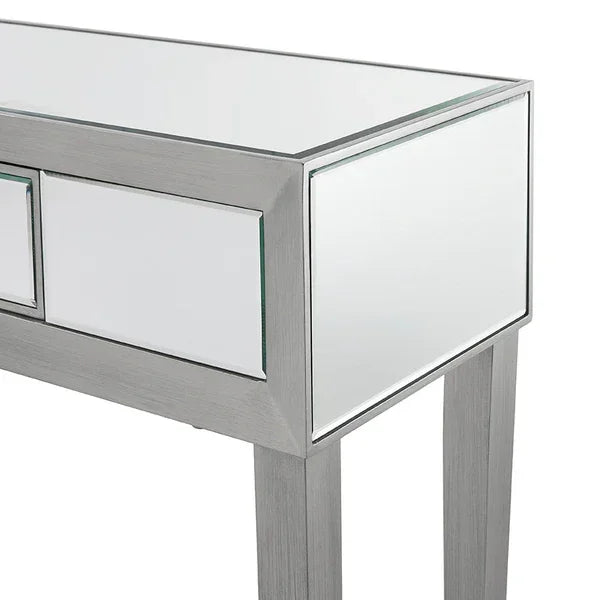Mirrored console table with silver frame and clean lines, partial side angle view
