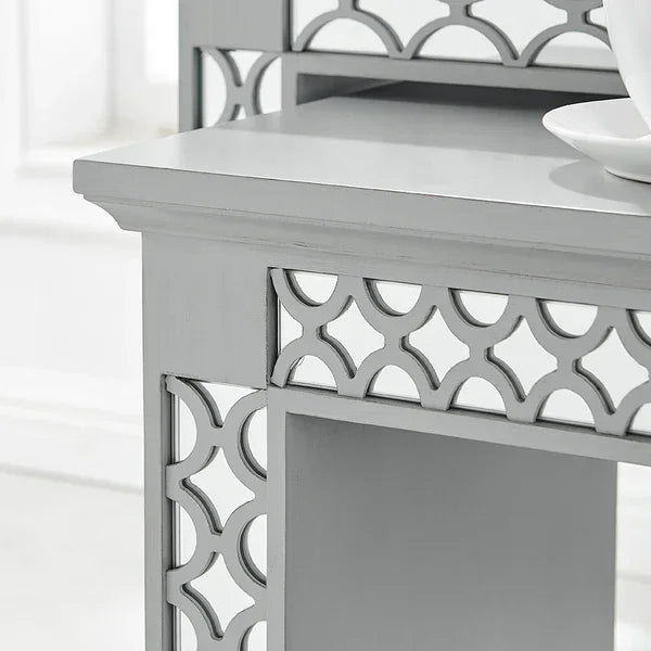 Grey wooden dressing table with decorative cut out design and smooth tabletop detail