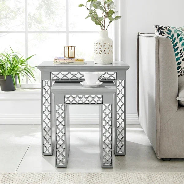 Grey nest of tables with geometric metal legs beside sofa in bright living room