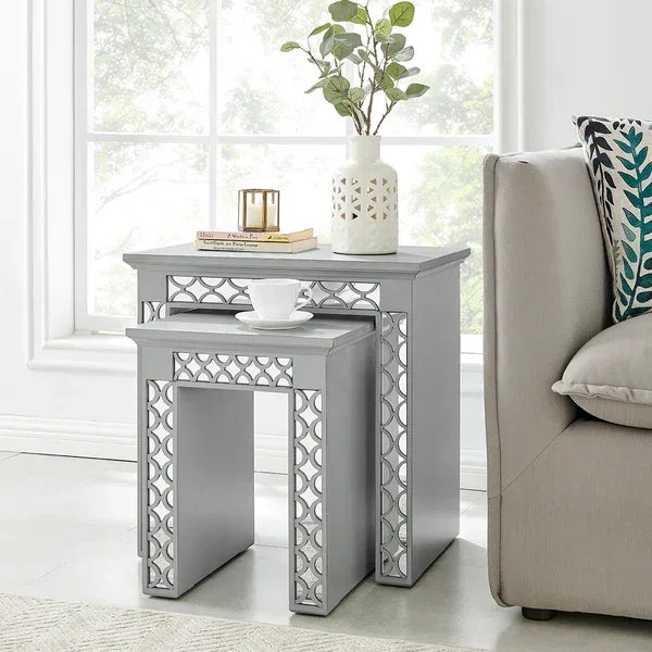Grey nesting tables with geometric pattern beside sofa in bright living room