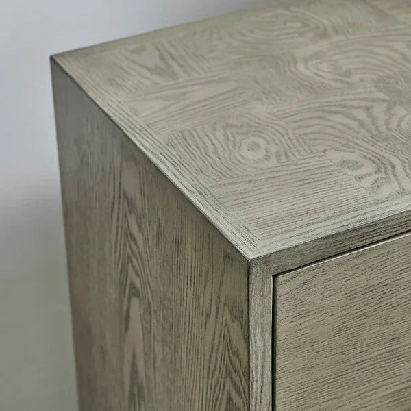 Close-up of light wood bedside table corner with visible grain texture