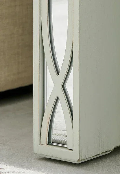 Distressed wooden side table leg with mirrored panel and lattice detail