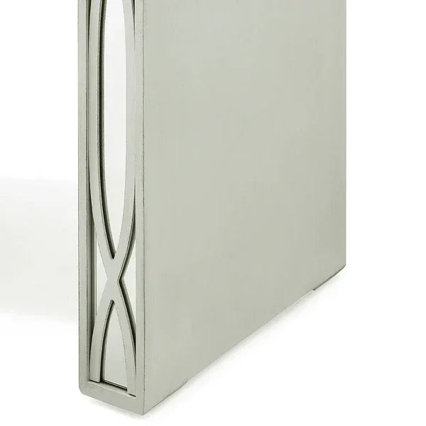Brushed metal dining table leg with geometric cutout pattern, close-up view