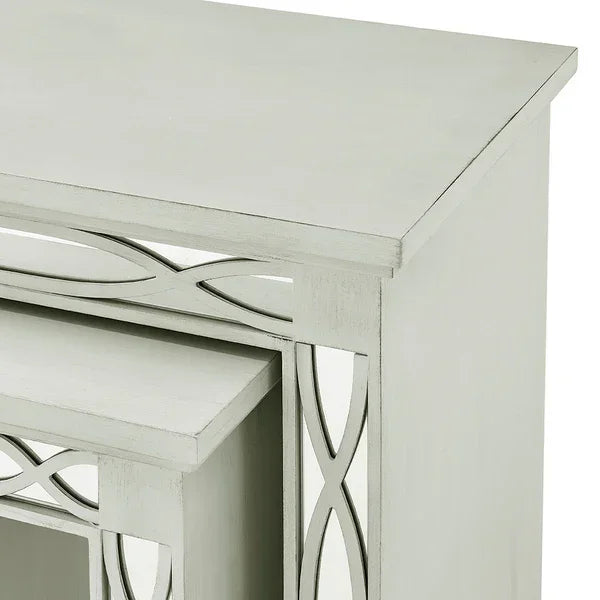 White wood nesting tables with mirrored panel details and geometric cutout design