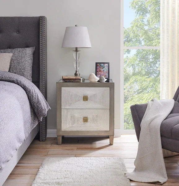 Modern wooden bedside table with two drawers beside upholstered bed in bright bedroom