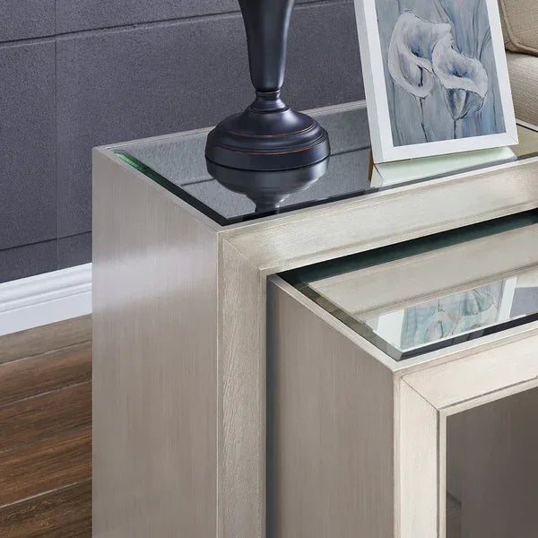 Modern glass top nest of tables with silver finish, styled with lamp and framed art