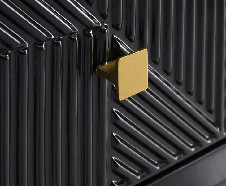 Black cabinet door with gold square handle and textured geometric pattern