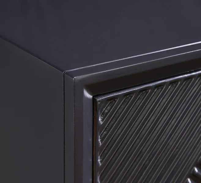 Closeup of black metal cabinet with textured diagonal pattern on front panel