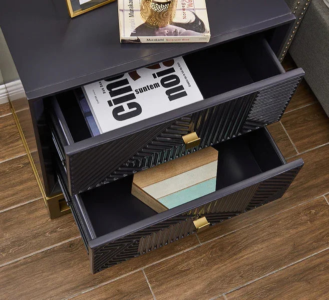 Black bedside table with gold handles and open drawers on wooden floor