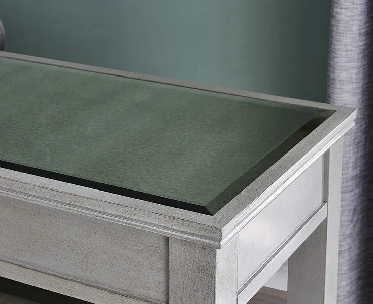 Grey wooden coffee table with tinted glass top, close-up of tabletop and corner detail