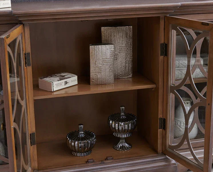 Wooden display cabinet with glass doors, silver textured vases, and glass storage jars