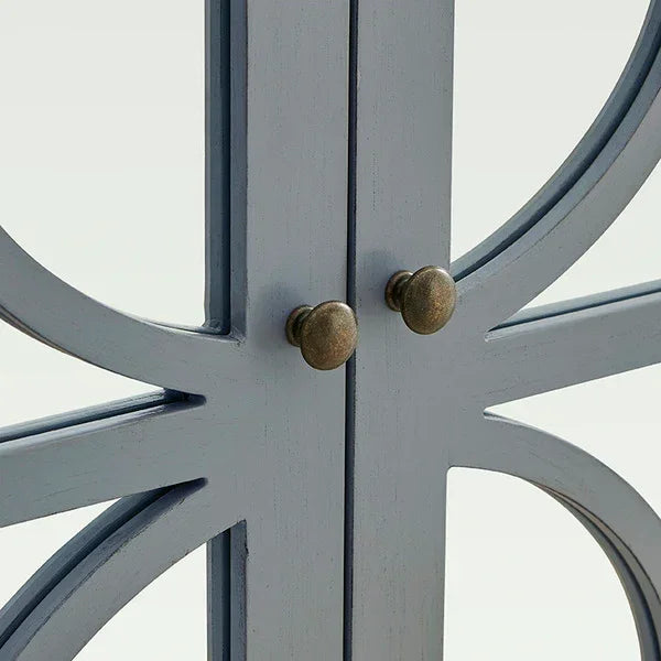 Blue painted cabinet doors with round brass handles and decorative wooden detailing
