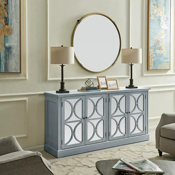 Modern grey sideboard with geometric doors, two table lamps, and round mirror in living room