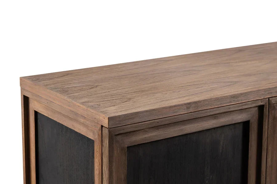 Closeup of wood sideboard corner with natural grain top and black panel detail