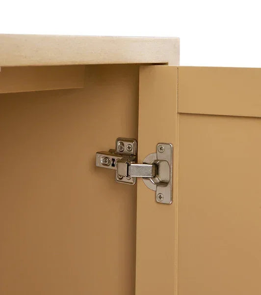Closeup of cabinet hinge on light wood cupboard door
