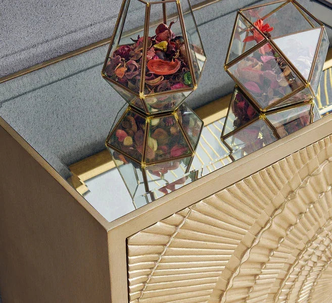 Mirrored console table with gold textured front and geometric glass decor vases