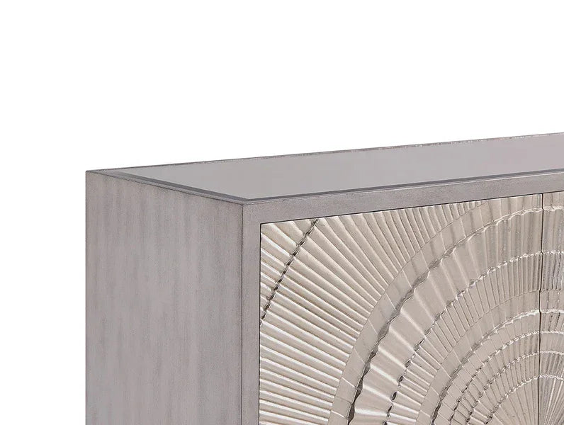 Grey wooden cabinet with textured metallic sunburst detail on the front panel