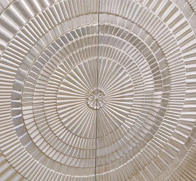 Textured cabinet door panel with circular geometric pattern in cream finish