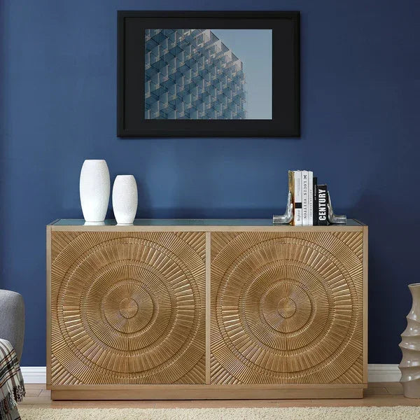 Wooden sideboard with geometric carved doors against blue wall, decorated with vases and books