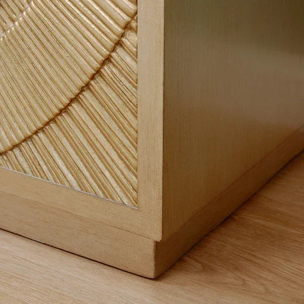 Textured wood furniture corner with light oak finish and carved geometric panel detail