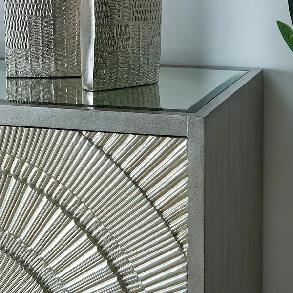 Silver metallic sideboard with sunburst pattern and glass top corner view