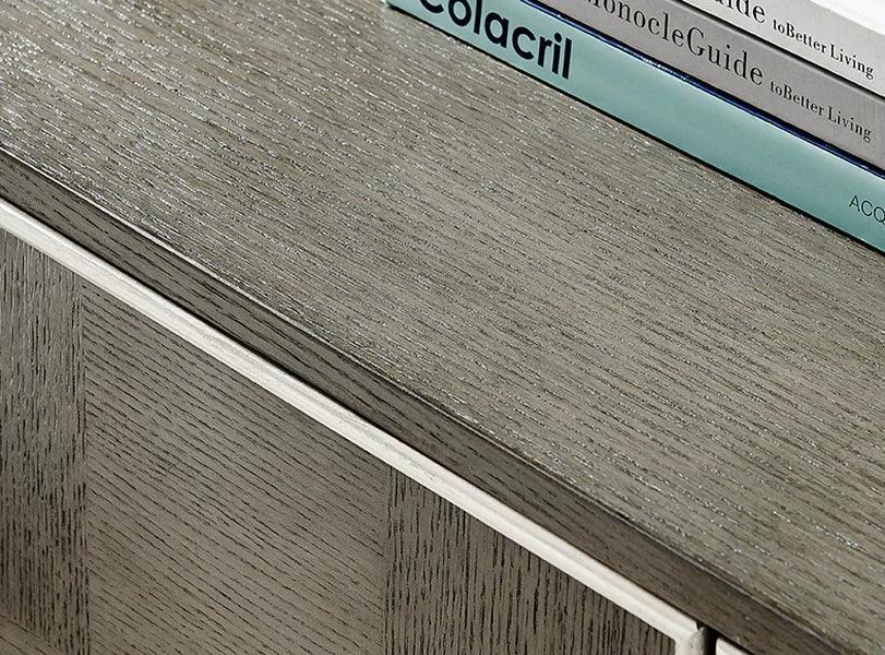 Closeup of grey wood sideboard top with visible texture and stacked books