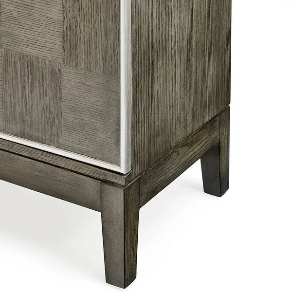 Corner view of grey wood cabinet with checkered panel design and square legs