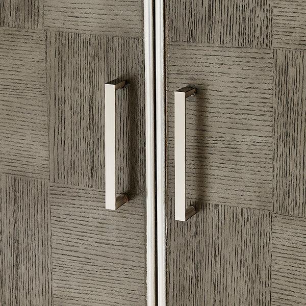 Close-up of cabinet doors with silver handles and textured wood finish