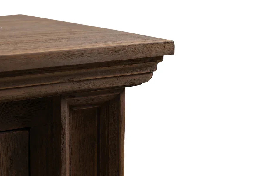 Close up of wooden sideboard corner with dark brown finish and paneled detailing