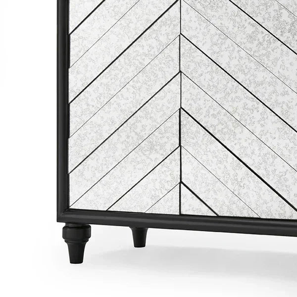 Mirrored furniture cabinet corner with chevron pattern and black wood frame
