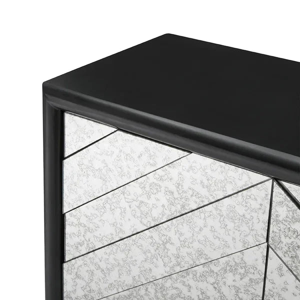 Black wood chest of drawers with angled antique mirror panels