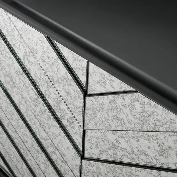 Close-up of mirrored chest of drawers with chevron pattern and textured glass panels