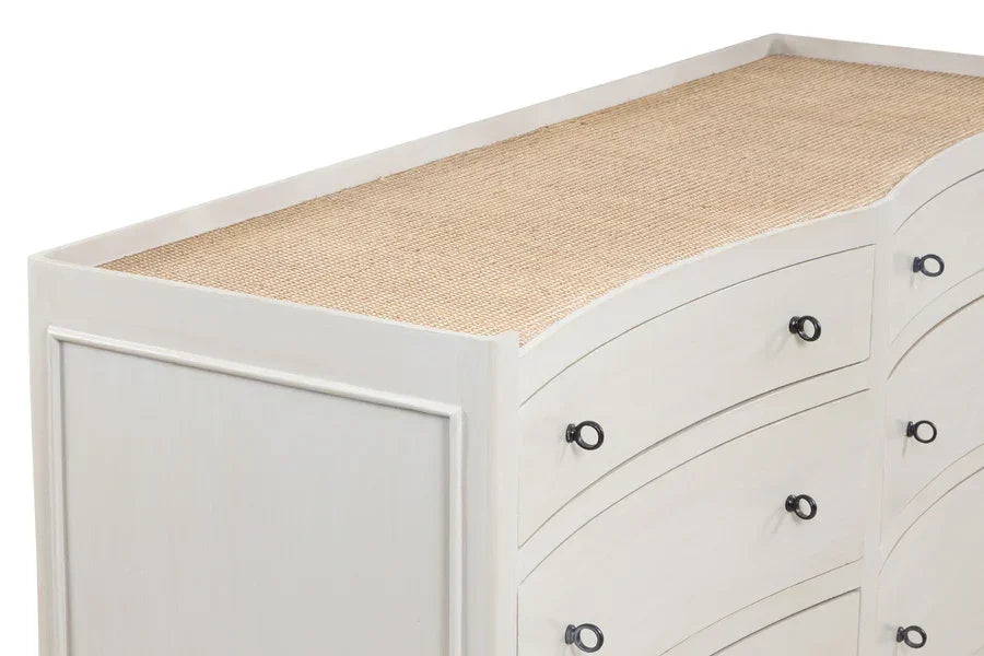 White wooden chest of drawers with black metal handles and textured top surface