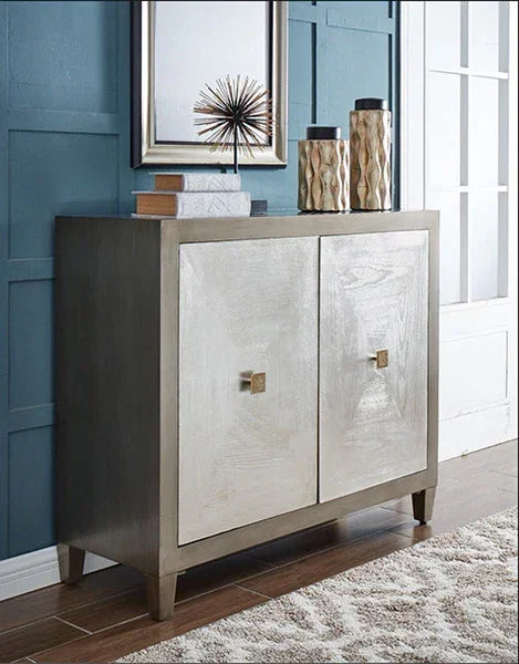 Modern wood sideboard with metallic doors and decorative items, set against blue paneled wall