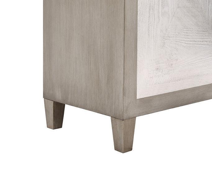 Close-up of wooden cabinet corner with tapered legs and light grey finish