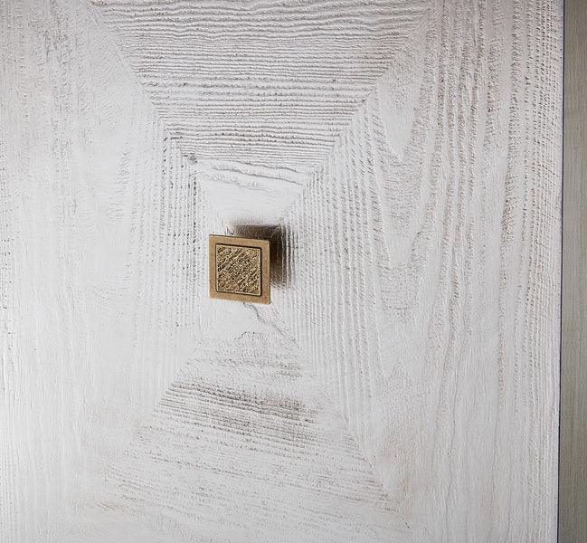 Close up of textured wooden cabinet door with square brass handle