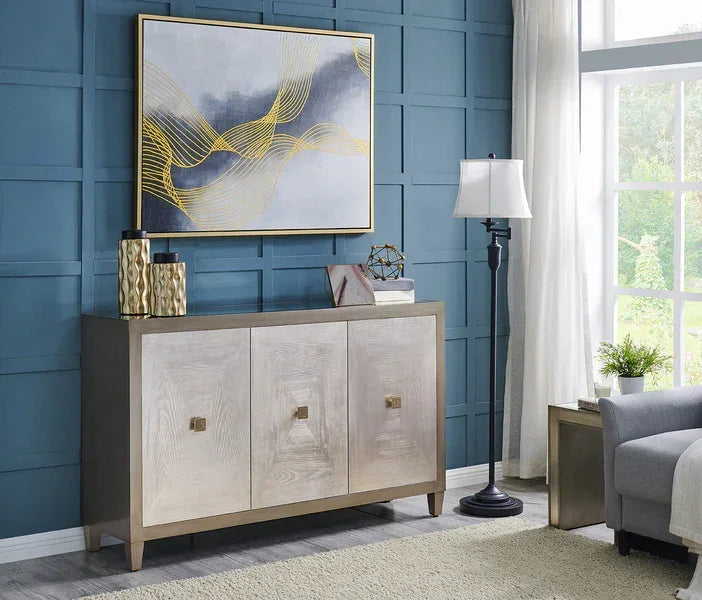 Modern sideboard with wood finish, gold handles, and decorative items in a living room