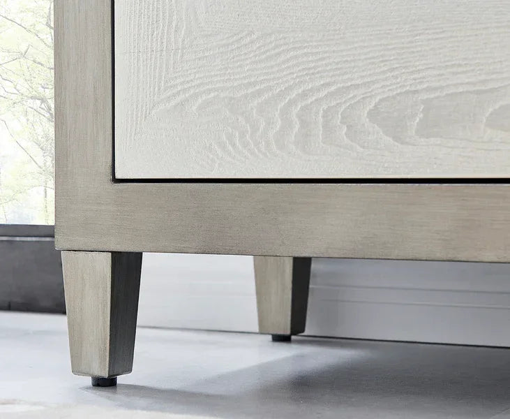 Light oak wood furniture legs with visible grain on a modern cabinet base