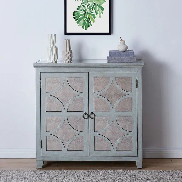 Grey wooden sideboard with geometric panel doors and decorative vases on top