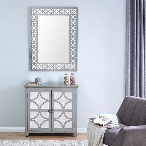 Grey mirrored cabinet with geometric design and matching wall mirror in modern living room