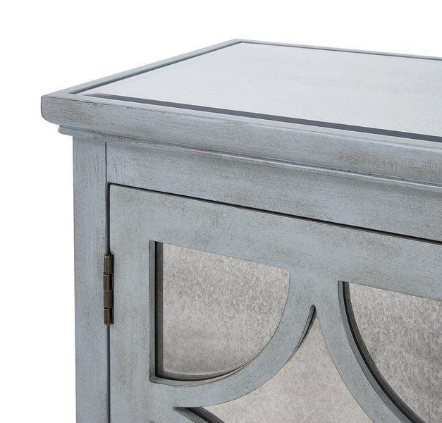 Close-up of light grey wooden cabinet with mirrored door and decorative trim
