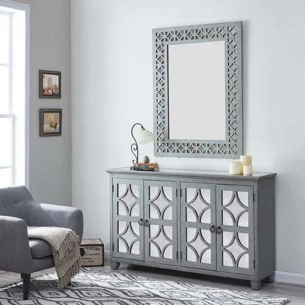 Grey wooden sideboard with geometric doors and matching wall mirror in modern living room