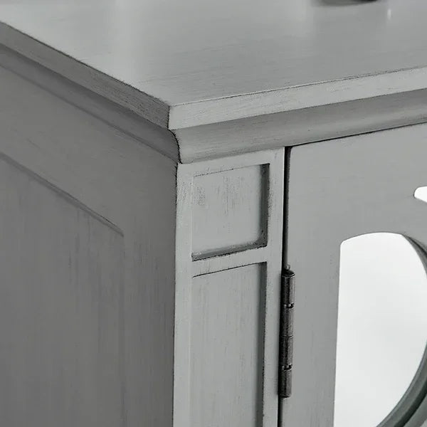 Grey wooden cabinet corner with panel detailing and round glass door inset