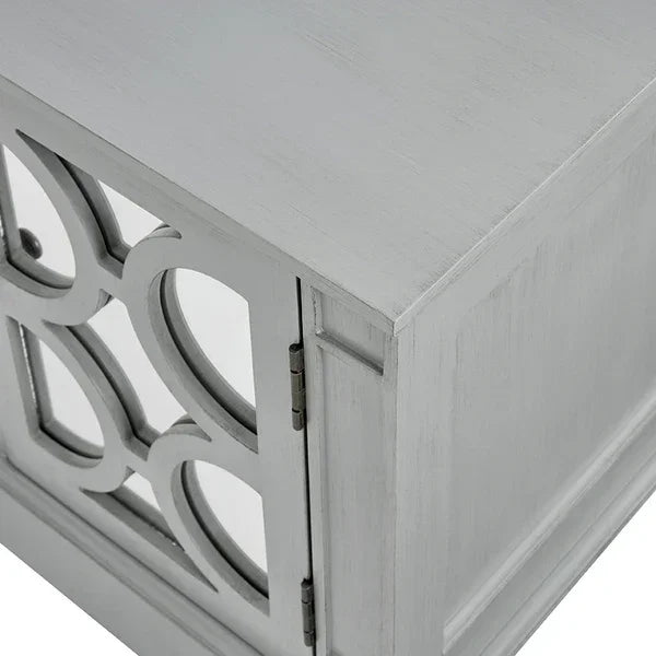 Light grey wooden cabinet corner with mirrored geometric panel detail