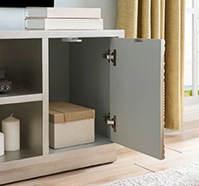 Modern TV unit with open grey cabinet door, storage shelves, and decorative box inside