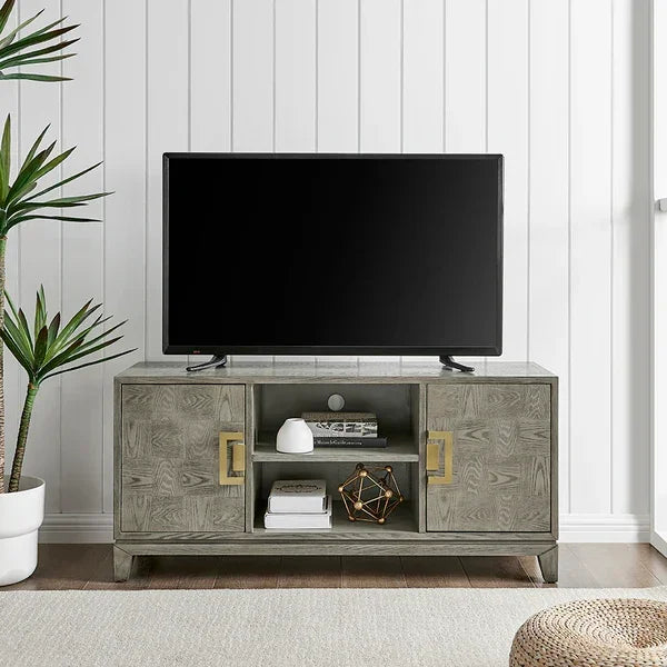Grey wood TV unit with gold handles, two doors, open shelves, and modern decor