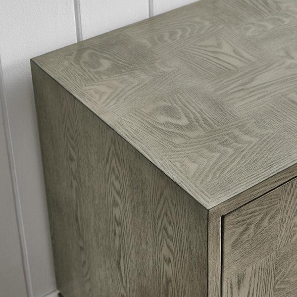 Close view of modern wooden cabinet with light oak finish and textured grain pattern